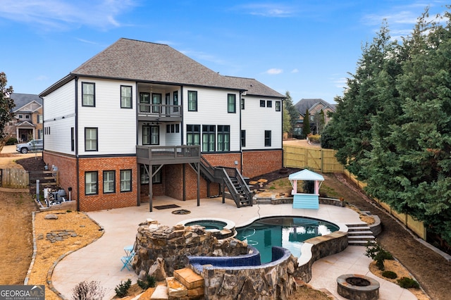5 Greywood Ln, Cartersville, GA 30120 - rear view of property with stairs, a balcony, brick siding, an outdoor fire pit, and a fenced backyard