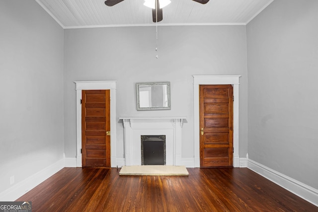 unfurnished living room featuring crown molding, a fireplace with raised hearth, and wood finished floors