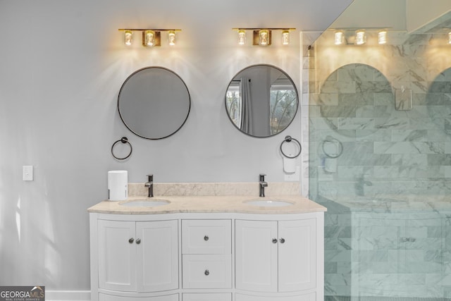 full bath with double vanity, a tile shower, and a sink