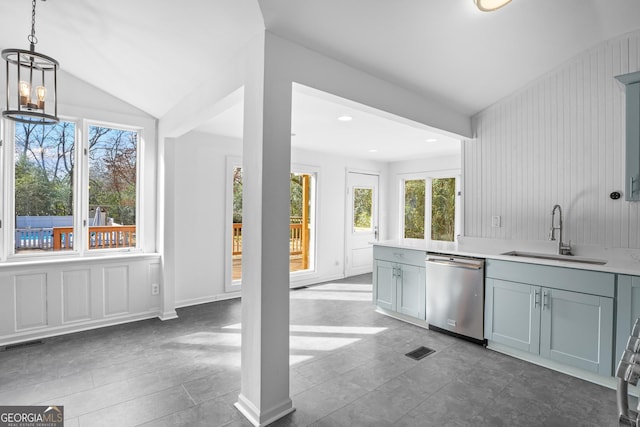 kitchen featuring light countertops, visible vents, vaulted ceiling, a sink, and dishwasher