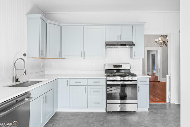 kitchen featuring a notable chandelier, light countertops, appliances with stainless steel finishes, a sink, and under cabinet range hood