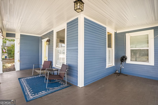 view of patio / terrace with a porch and visible vents