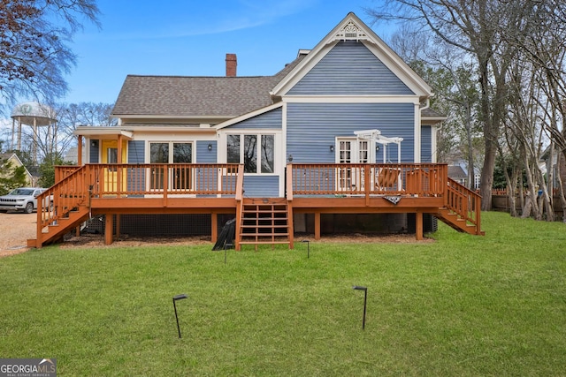 rear view of house featuring a yard, a shingled roof, stairway, and a chimney