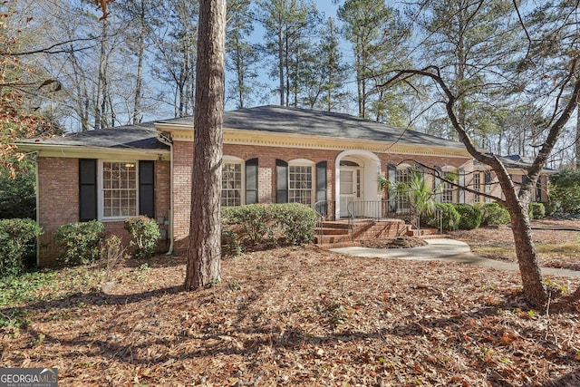 view of front facade featuring covered porch and brick siding