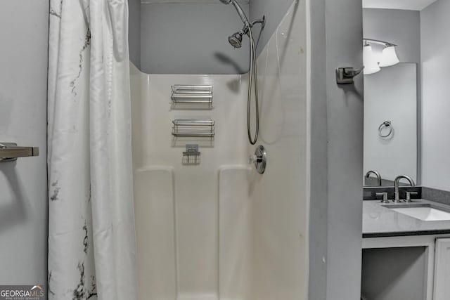 bathroom featuring vanity and a shower with shower curtain