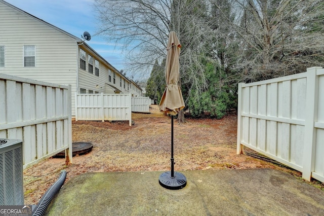 view of yard featuring a patio area, central AC, and fence