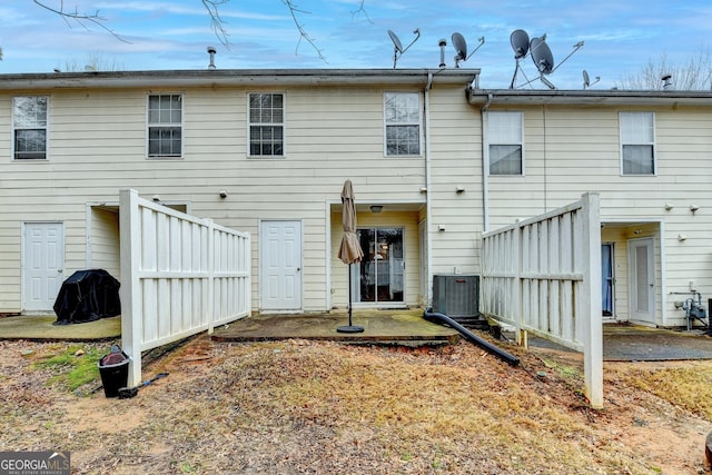 rear view of house with cooling unit