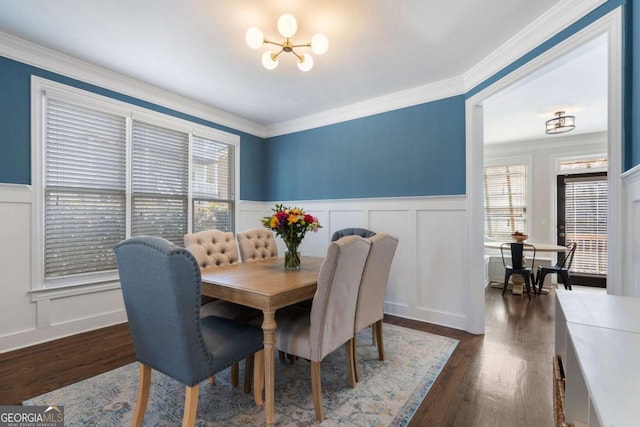 dining area with crown molding, dark wood finished floors, and a wealth of natural light