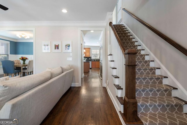 stairs featuring crown molding, wood finished floors, and recessed lighting