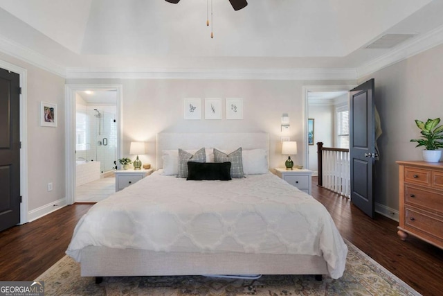 bedroom with dark wood finished floors, visible vents, ensuite bathroom, ornamental molding, and baseboards