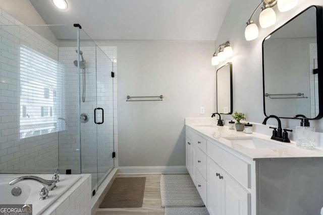 bathroom featuring lofted ceiling, a shower stall, baseboards, and a sink