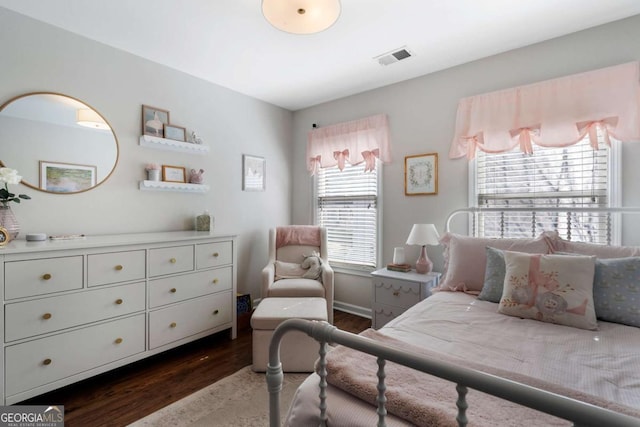 bedroom with baseboards, multiple windows, visible vents, and dark wood-style flooring