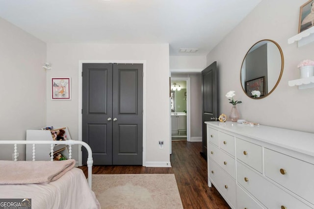 bedroom featuring baseboards, a closet, visible vents, and dark wood-style flooring