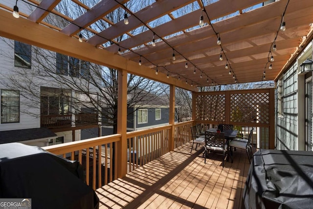 wooden deck featuring outdoor dining area, a grill, and a pergola