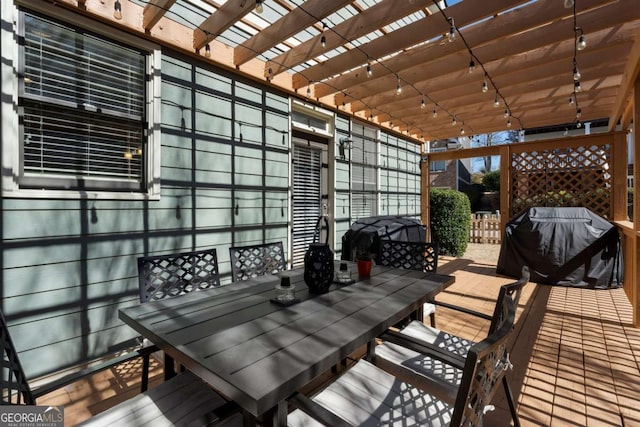 wooden terrace with grilling area and outdoor dining area