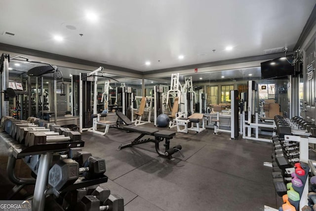 gym featuring ornamental molding and recessed lighting