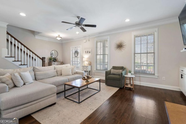 living area with baseboards, ornamental molding, and wood finished floors