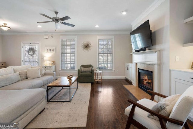 living area featuring crown molding, recessed lighting, a high end fireplace, wood finished floors, and baseboards