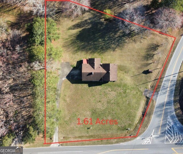 rear view of property with central AC unit, a lawn, and a chimney