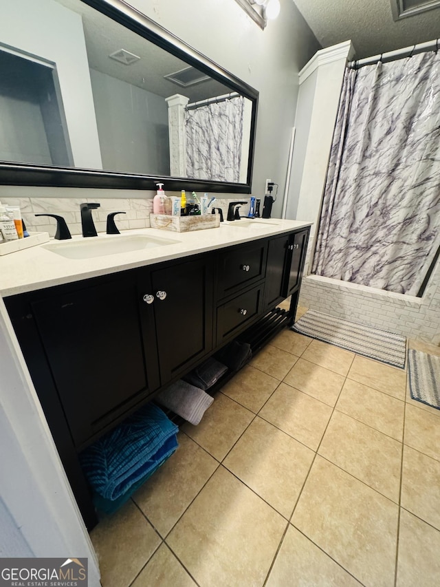 full bathroom with a textured ceiling, visible vents, a sink, and tile patterned floors