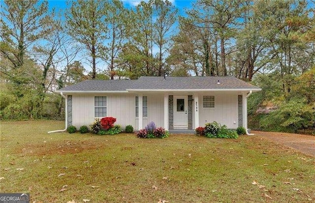 ranch-style home with a front lawn