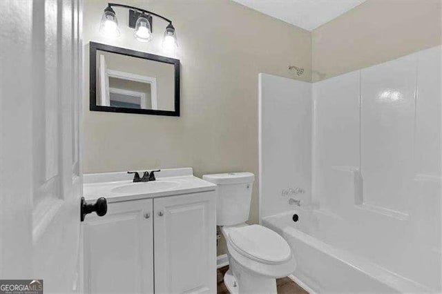 bathroom featuring toilet, washtub / shower combination, and vanity