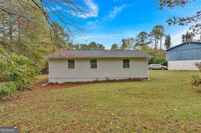 view of side of home featuring a lawn