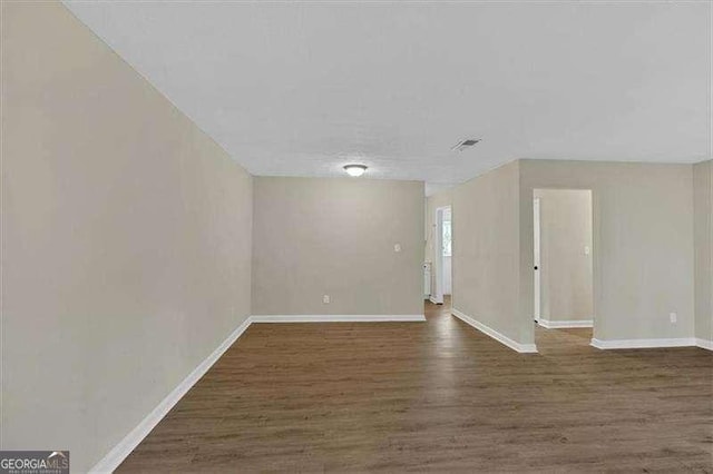 interior space with visible vents, baseboards, and wood finished floors