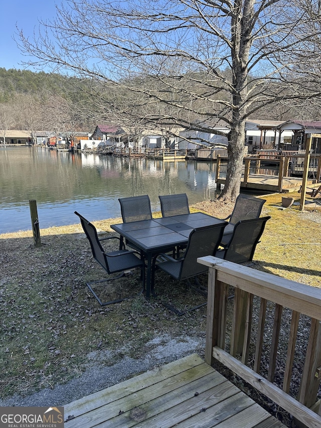 wooden terrace featuring a water view