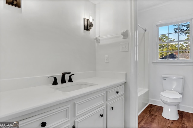 bathroom with toilet, shower / bath combo with shower curtain, vanity, wood finished floors, and baseboards