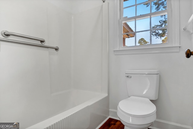 full bathroom featuring shower / tub combination, toilet, and baseboards