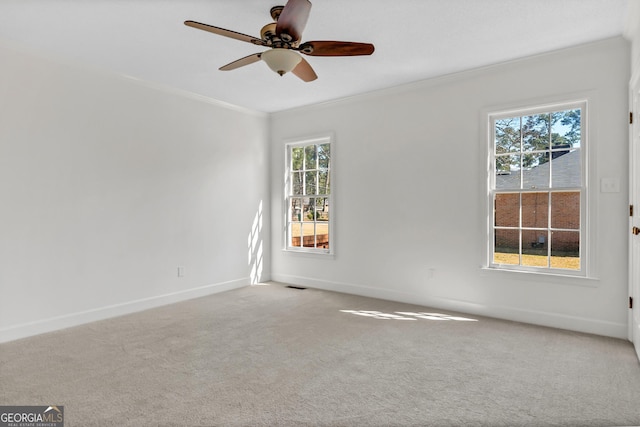 unfurnished room featuring carpet floors, ornamental molding, visible vents, and baseboards