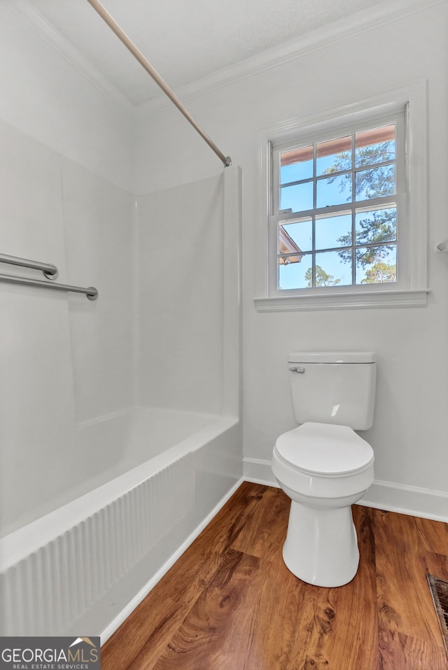 full bath featuring crown molding, wood finished floors, toilet, and baseboards