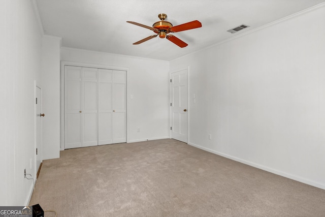 unfurnished bedroom with visible vents, ornamental molding, and light colored carpet