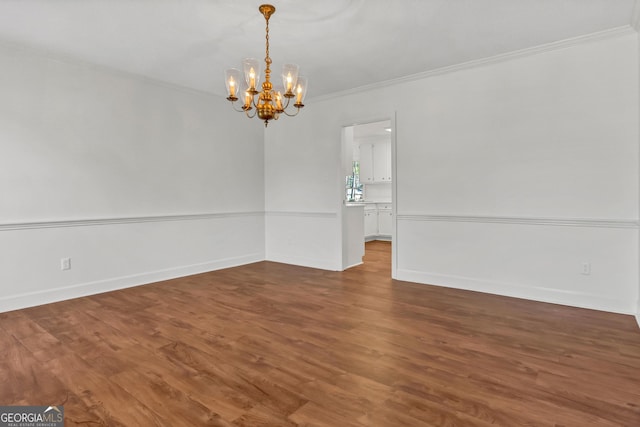 interior space with ornamental molding, baseboards, and wood finished floors