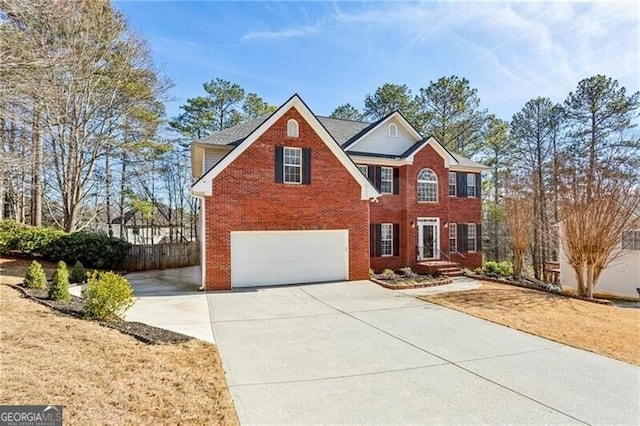 view of front of house with driveway, a garage, and brick siding