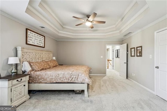 bedroom featuring light colored carpet, ornamental molding, and a raised ceiling