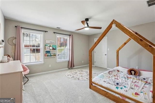 bedroom with visible vents, baseboards, ceiling fan, and light colored carpet