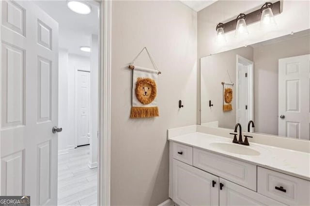 bathroom featuring wood finished floors and vanity