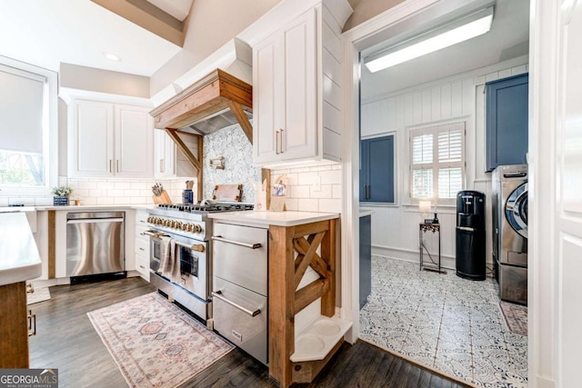 kitchen with white cabinetry, stainless steel appliances, light countertops, and custom range hood