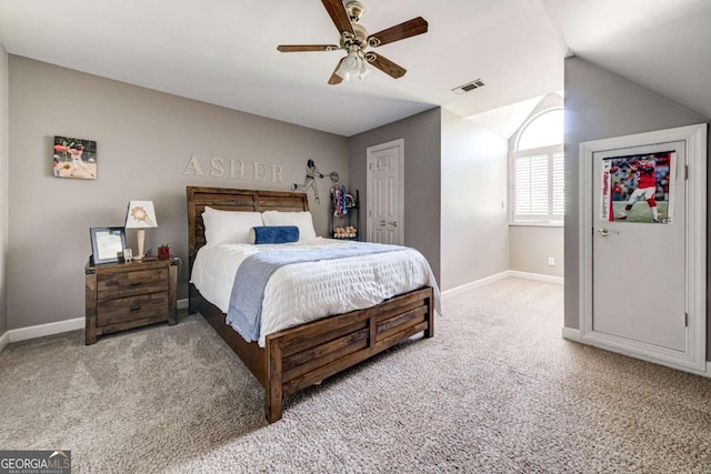 bedroom featuring lofted ceiling, visible vents, a ceiling fan, baseboards, and light colored carpet