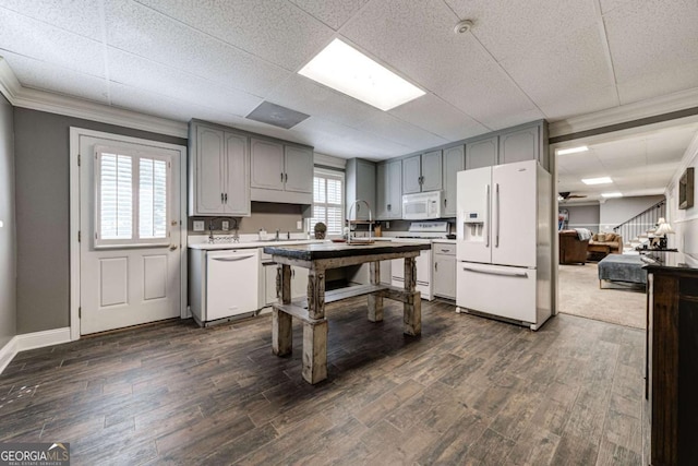 kitchen with light countertops, dark wood finished floors, gray cabinetry, and white appliances