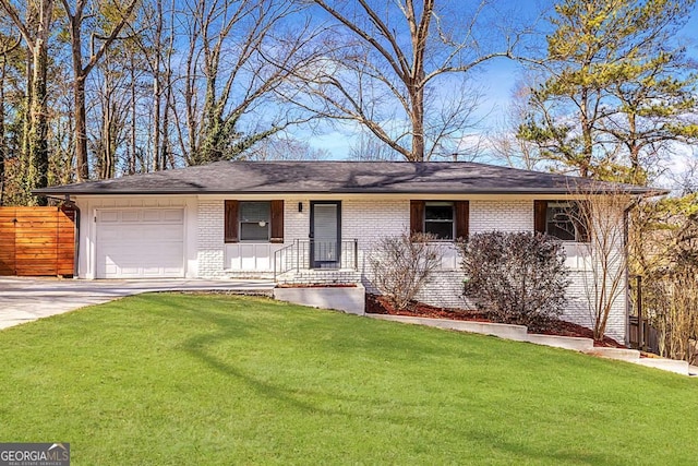 ranch-style home with a front yard, brick siding, driveway, and an attached garage