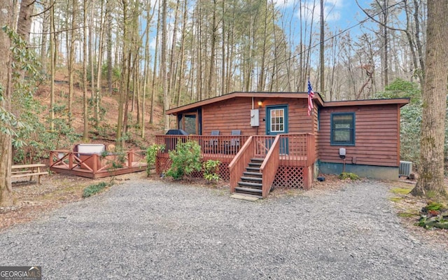 chalet / cabin featuring a wooden deck and central AC