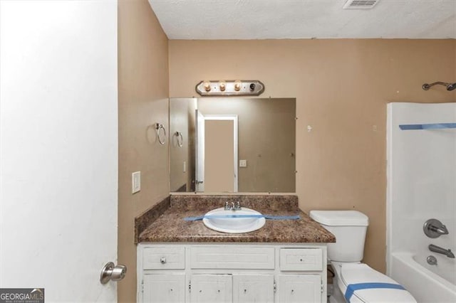 bathroom with toilet, visible vents, shower / bathtub combination, and vanity