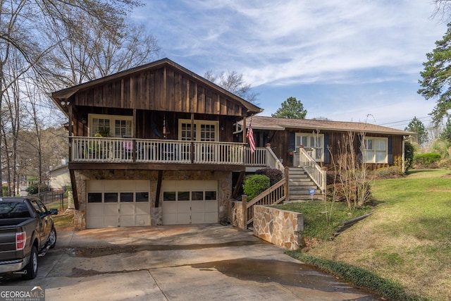 view of front facade featuring a garage, stone siding, stairway, and driveway