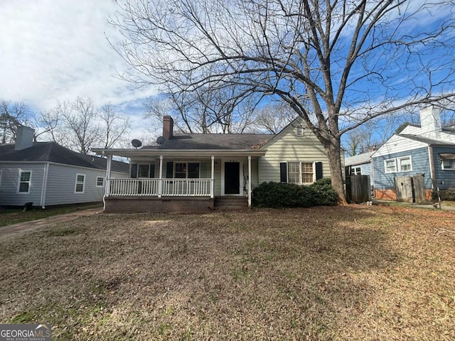 view of front of house with covered porch and a chimney