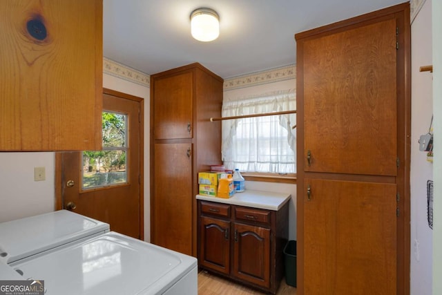 clothes washing area with cabinet space and washing machine and clothes dryer