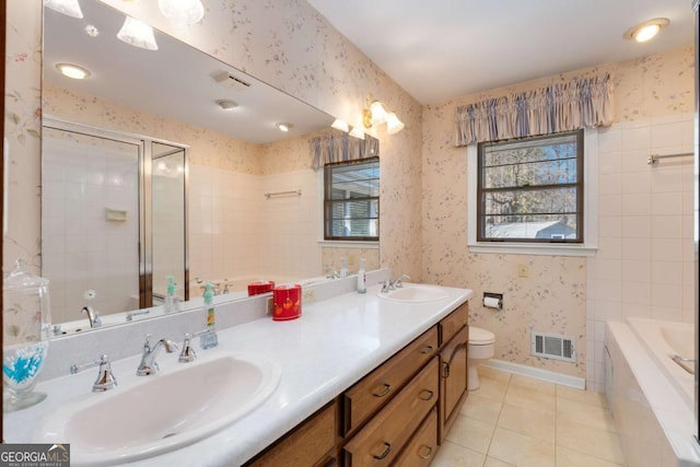 bathroom with baseboards, a sink, and wallpapered walls