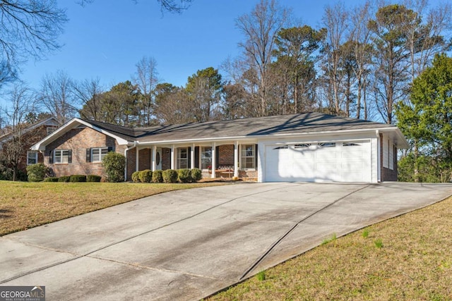 ranch-style home featuring an attached garage, brick siding, concrete driveway, and a front yard